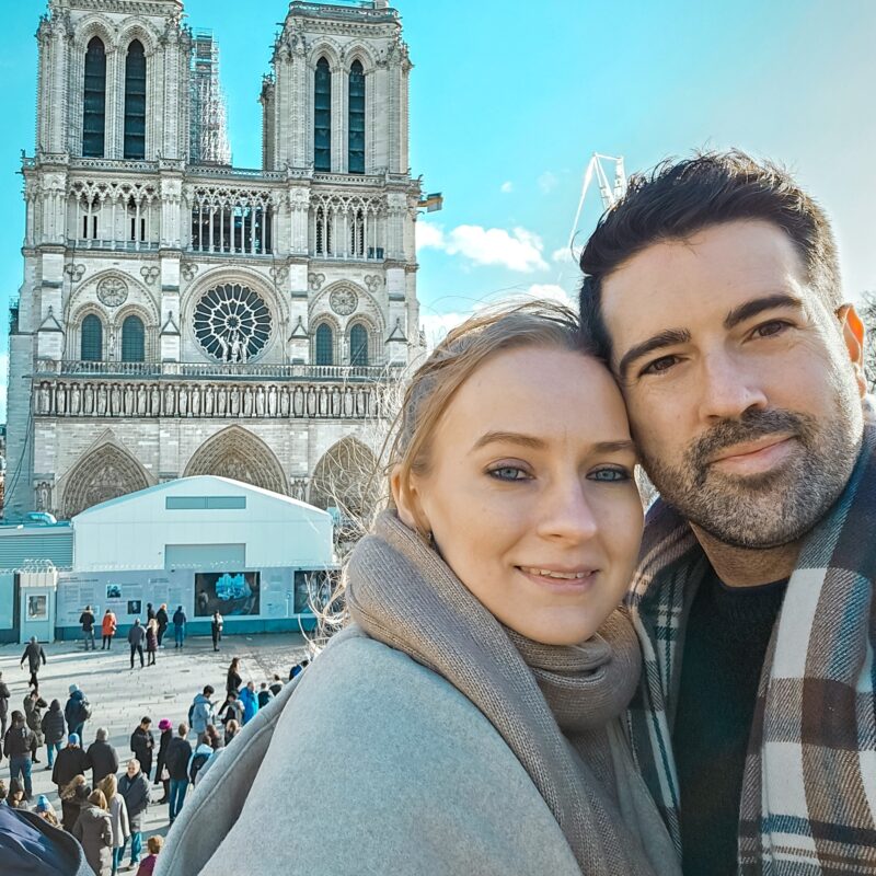 Romantic Photo Spots in Paris for Couples - Travel Couple taking a selfie with the Notre Dame