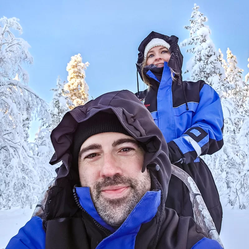 What to expect from Husky Sledding in Finnish Lapland as a couple - Couple taking a selfie during Husky Sledding safari in Finnish Lapland