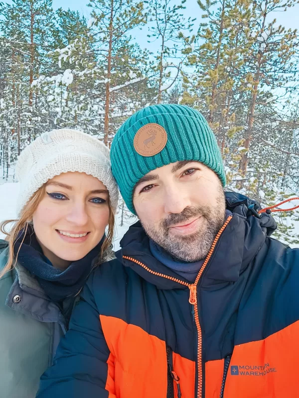 What to wear in Finnish Lapland in winter - Couple dressed for the Arctic cold with hat, ear warmers, tube scarfs and ski jackets