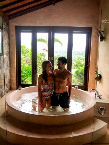 Romantic hot tub with garden views in the bathroom of Villa Sidemen Bali